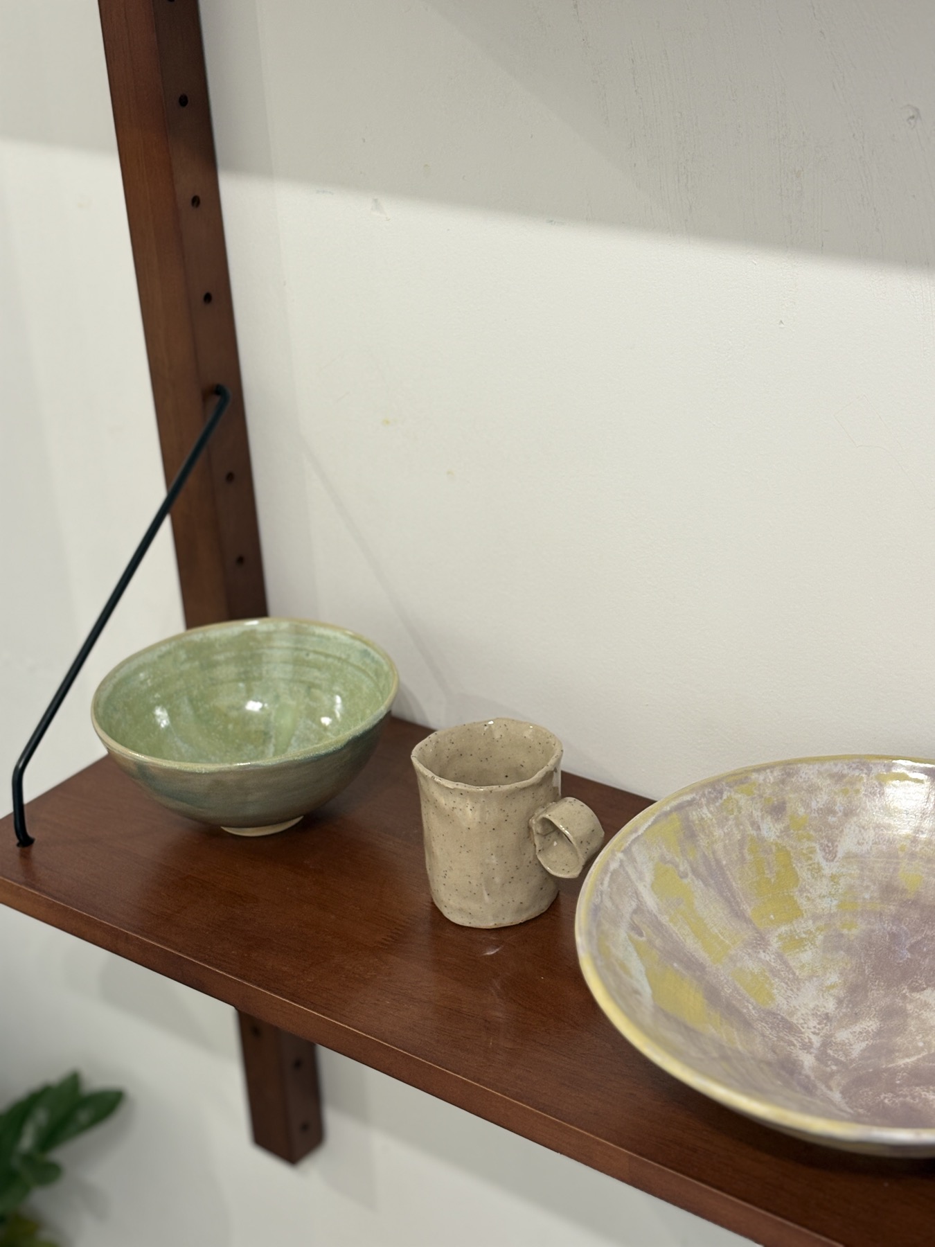 Ceramic pieces on a wooden shelf