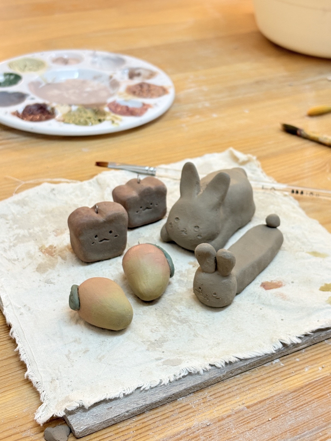 Small clay characters on a work table